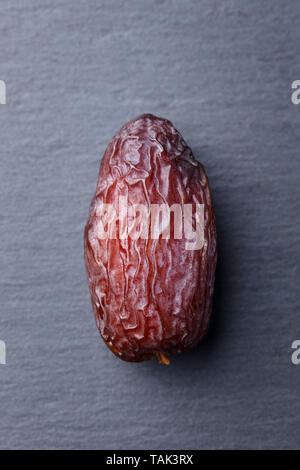 Fresh Medjool Dates. Grey slate background. Close up. Top view. Stock Photo