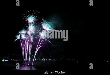 Gorgeous blue and purple fireworks against the night sky with free space Stock Photo