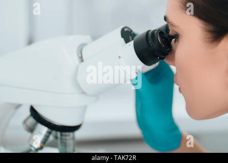 Technician using microscope in lab, close-up. Laboratory technician and microscope, macro Stock Photo