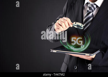 5g tablet on businessman hand connect worldwide. 5G network connection concept. Stock Photo