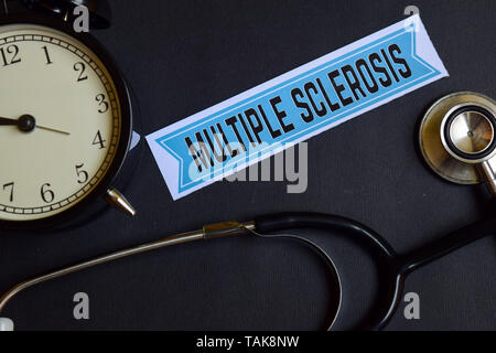 Multiple Sclerosis on the print paper with Healthcare Concept Inspiration. alarm clock, Black stethoscope. Stock Photo