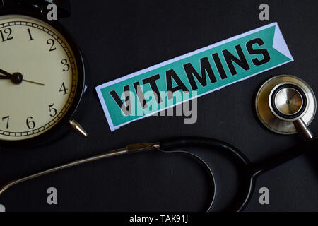 Vitamins on the print paper with Healthcare Concept Inspiration. alarm clock, Black stethoscope. Stock Photo