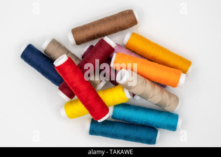 spool of thread many of different colors isolated on white background Stock Photo