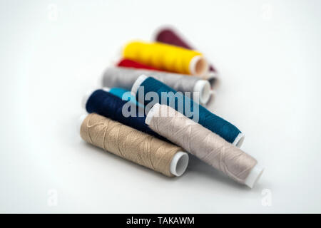 spool of thread many of different colors isolated on white background Stock Photo