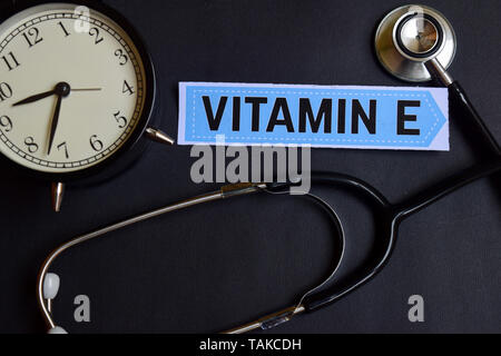 Vitamin E on the paper with Healthcare Concept Inspiration. alarm clock, Black stethoscope. Stock Photo
