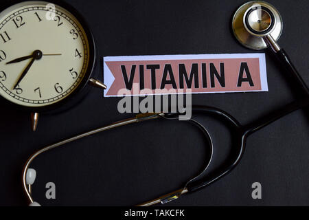 Vitamin A on the paper with Healthcare Concept Inspiration. alarm clock, Black stethoscope. Stock Photo