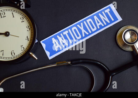 Antioxidant on the paper with Healthcare Concept Inspiration. alarm clock, Black stethoscope. Stock Photo