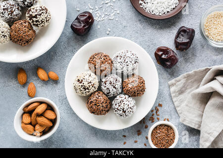 Vegan chocolate protein energy balls with dates, seeds and nuts on concrete background. Top view. Flat lay Stock Photo