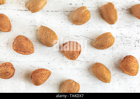 Top down view, whole almonds in shell on stone board Stock Photo