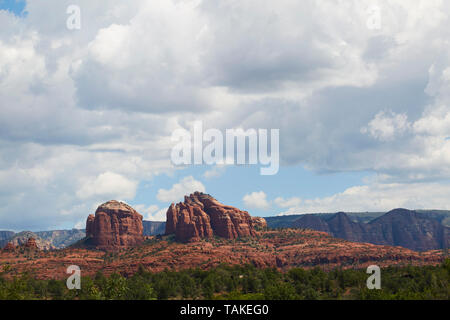 Red Rock canyons with rock formations against blue sky and fluffy white clouds. Stock Photo