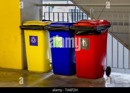 Yellow, blue,red recycle trash bin and recycle symbol Stock Photo