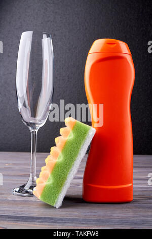 https://l450v.alamy.com/450v/takfw8/accessories-for-dishwashing-and-house-cleaning-bottle-of-detergent-glass-and-sponge-on-dark-background-dishwashing-concept-takfw8.jpg