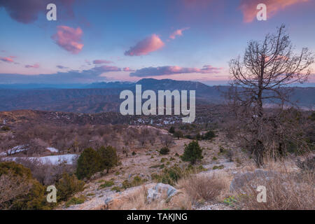 Lonely sunset above Monodendri, Greece. Vikos gorge country during a colorful sunset. Painted sky above the mountains and valley in Zagoria, Greece. Stock Photo