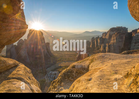 Golden hour sunset from sunset rock in Meteora, Greece, overlooking Roussanou and Grand Meteora monasteries in the valley. Stock Photo