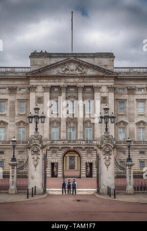 London UK. 25th May 2019. Police security guard the front of Buckingham Palace open gateway before the Major Generals Review of Trooping the Colour. Stock Photo