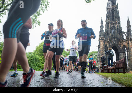 Competitors taking part in the 2019 Edinburgh Marathon Festival half marathon run through Princes Street Gardens in the rain. Stock Photo