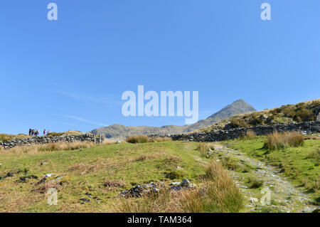 People walking on slopes of Cnicht mountain Snowdonia Stock Photo