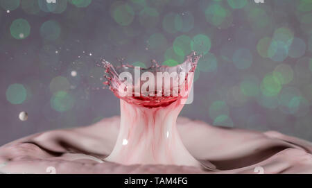 Red drop falling into white liquid, causing amazing unique ripples. Droplet photography, vivid colours and contrasts Stock Photo
