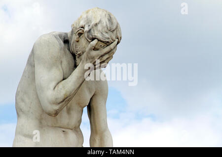 Facepalm - ashamed, sad, depressed. Statue with head in hand Stock Photo