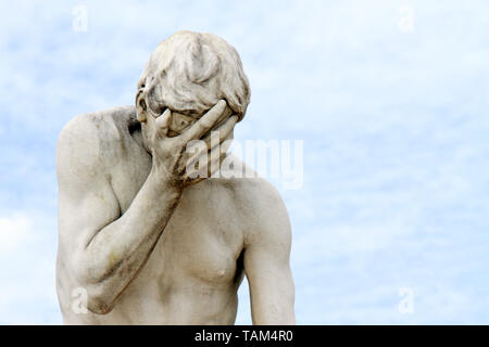 Facepalm - ashamed, sad, depressed. Statue with head in hand Stock Photo