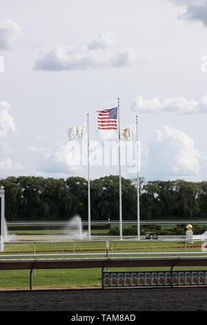 Flags on a flagpole at the Arlington International Racecourse in Arlington Heights, IL in the outfield. Stock Photo