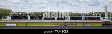 A sign at the Arlington International Racecourse with all of the bets, odds, countries flags and a blue sky behind. Owned by Churchill Downs. Stock Photo