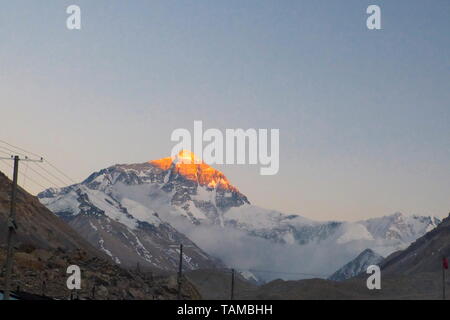 Morning sunrise at with an orange glow on the face of Mount Everest from the Mount Everest Base Camp from the Tibetan side. Stock Photo