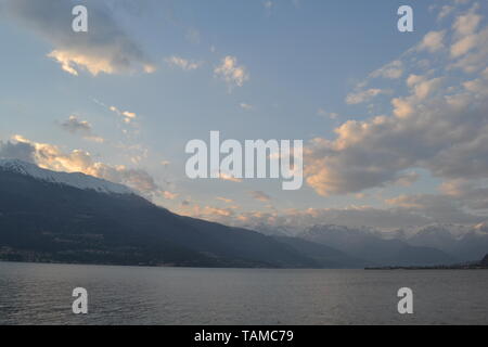 Beautiful sunset at the lake Como in spring and panoramic view to Dervio peninsula from Bellano. Stock Photo