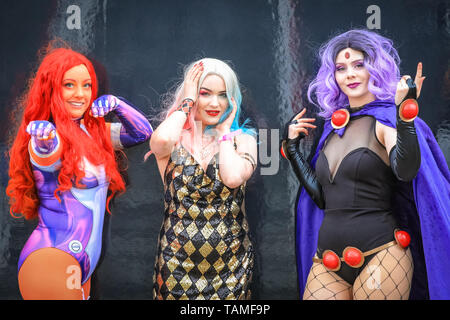 London, UK. 26th May, 2019. Three cosplayers pose in their DC Comics character outfits. MCM Comicon's third and final day once again sees thousands of cosplayers and fans of comics, games and sci fi and fantasy turn up in fantastic costumes and outfits at ExCel London to celebrate their favourite characters. Credit: Imageplotter/Alamy Live News Stock Photo