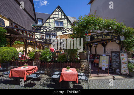 Wine tavern and beer garden at historic half-timbered house, Ruedesheim, Upper Middle Rhine Valley, Rheingau, Hesse, Germany Stock Photo
