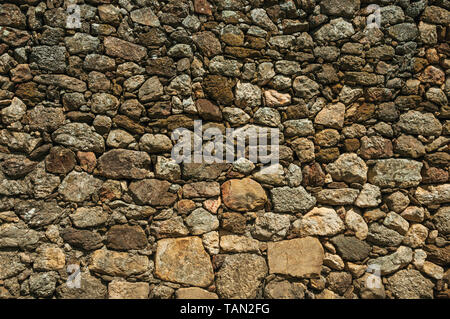 Old wall made of rough stones forming a singular background at Linhares da Beira. A medieval hamlet with unique architecture in eastern Portugal. Stock Photo
