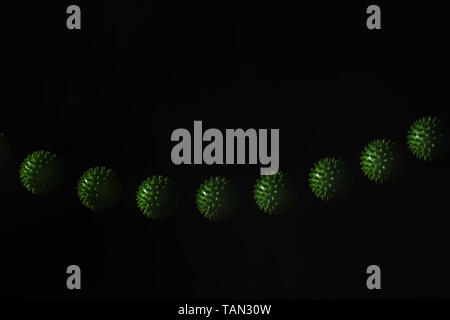 Stroboscopic photo of green moving ball on dark background Stock Photo