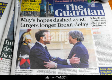 'May's hopes dashed as EU targets longer Brexit delay' in The Guardian front page newspaper headline as French President Emmanuel Macron greets Tory PM Theresa May in Paris France Europe EU on 9 April 2019 Stock Photo