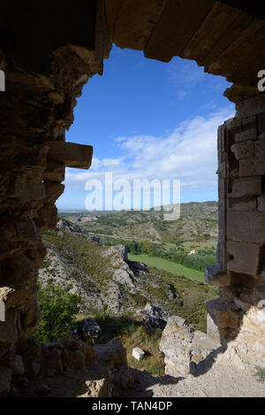 View over the Alpilles Hills through an Old Window in the Castellas or Château de Roquemartine Castle Eyguières Alpilles Provence France Stock Photo