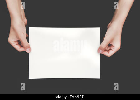 hands holding blank copy space letter on black background. Stock Photo