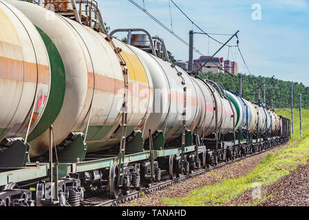 Long freight train approaches to the station. Stock Photo