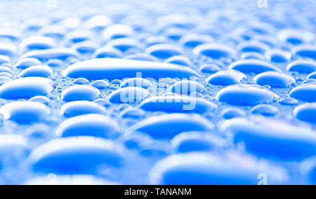 Transparent still water drops on light blue background. Blue water drops. Drops of rain on glass. Blue abstract water drop background. Water surface Stock Photo