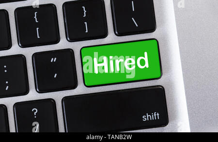 Hired text on green buttton of computer keyboard Stock Photo
