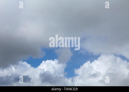 Weather clouds in blue sky. white and grey rain clouds with clear sky behind Stock Photo