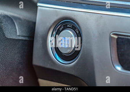 Close up view of an engine push start and stop button inside a vehicle. Interior of a vehicle with focus on the elements of the dashboard. Stock Photo