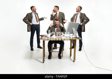 Internal problems. The young man suffering form colleagues laughing at him and constantly discussing. Phycology and mental pressed. Concept of office  Stock Photo