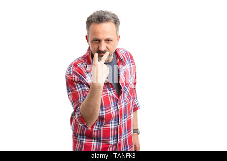 Serious man pointing fingers at eyes as watching you and eye contact concept isolated on white studio background Stock Photo