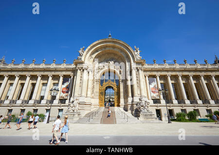 PARIS, FRANCE - JULY 21, 2017: Petit Palais building, people and tourists passing in a sunny summer day, clear blue sky in Paris, France. Stock Photo