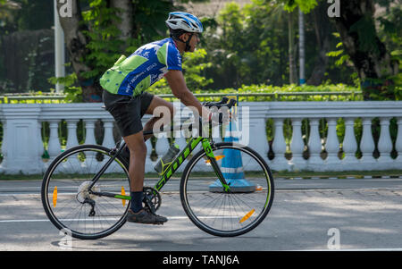 Kolkata, West Bengal / India - April 7, 2019: A young indian man riding bicycle in an urban city commuting with speed eco friendly and hipster trendy  Stock Photo