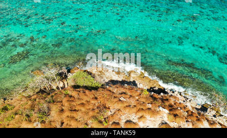 aerial view water surface with waves and coast tropical island. Lagoon with turquoise water. top view blue water Stock Photo