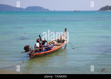 A long tail fishing boat in Rawai bay, Phuket, Thailand Stock Photo