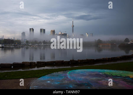 Fog rolls in over the Toronto skyline, featuring the CN Tower on a stormy afternoon Stock Photo