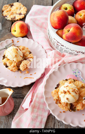 Peach crumble a la mode, with a scoop of vanilla ice cream Stock Photo