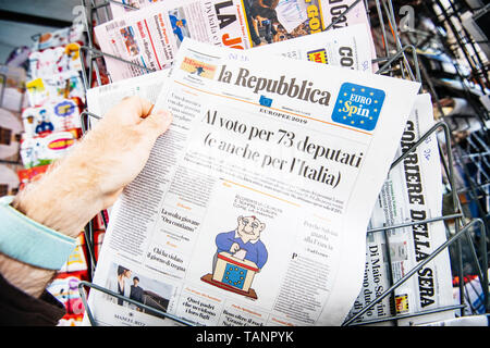Strasbourg, France - May 27, 2019: Man holding buying newspaper La Repubblica front page on street press kiosk newsstand with the results of 2019 European Parliament election  Stock Photo
