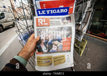 Strasbourg, France - May 27, 2019: Man holding buying Le republicain Lorrain newspaper front page on street press kiosk newsstand with the results of 2019 European Parliament election   Stock Photo
